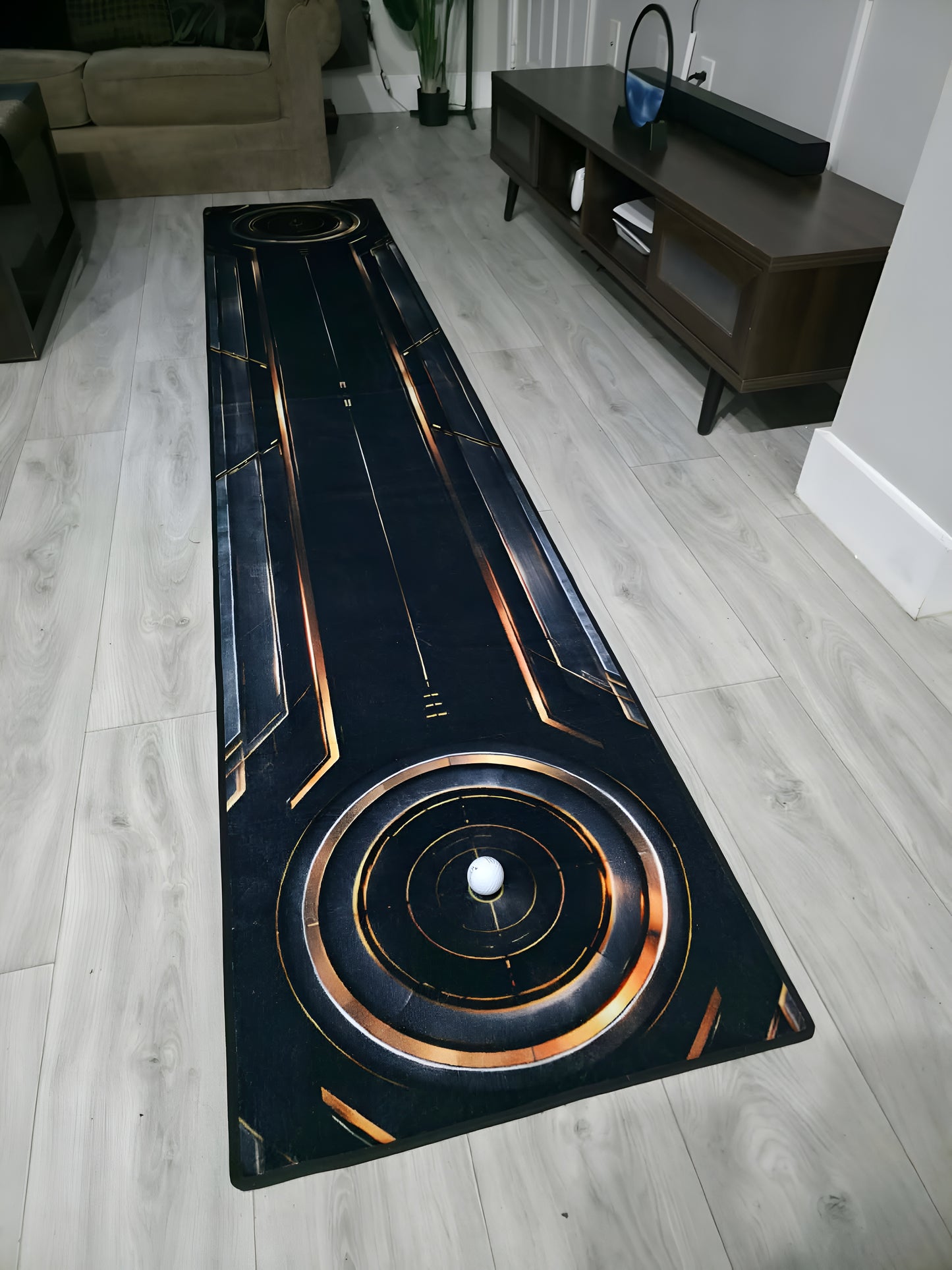 Full-length Eclipse™ designer putting rug with hidden indoor putting green for home practice.