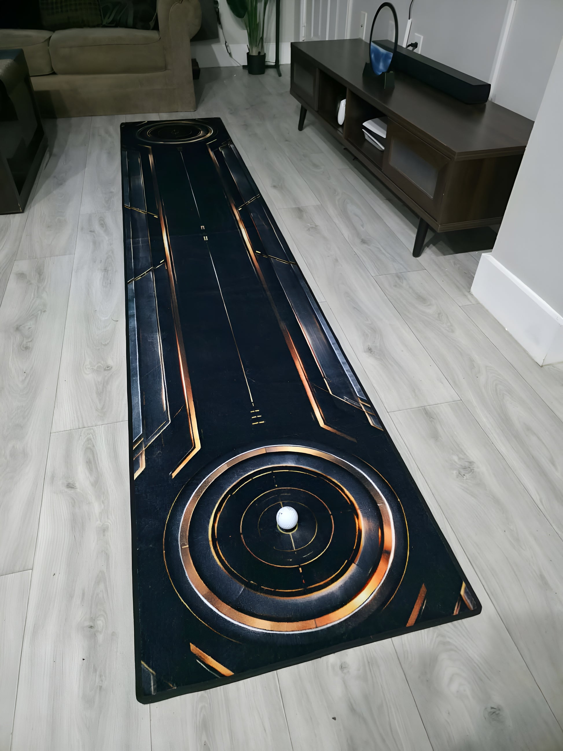 Full-length Eclipse™ designer putting rug with hidden indoor putting green for home practice.