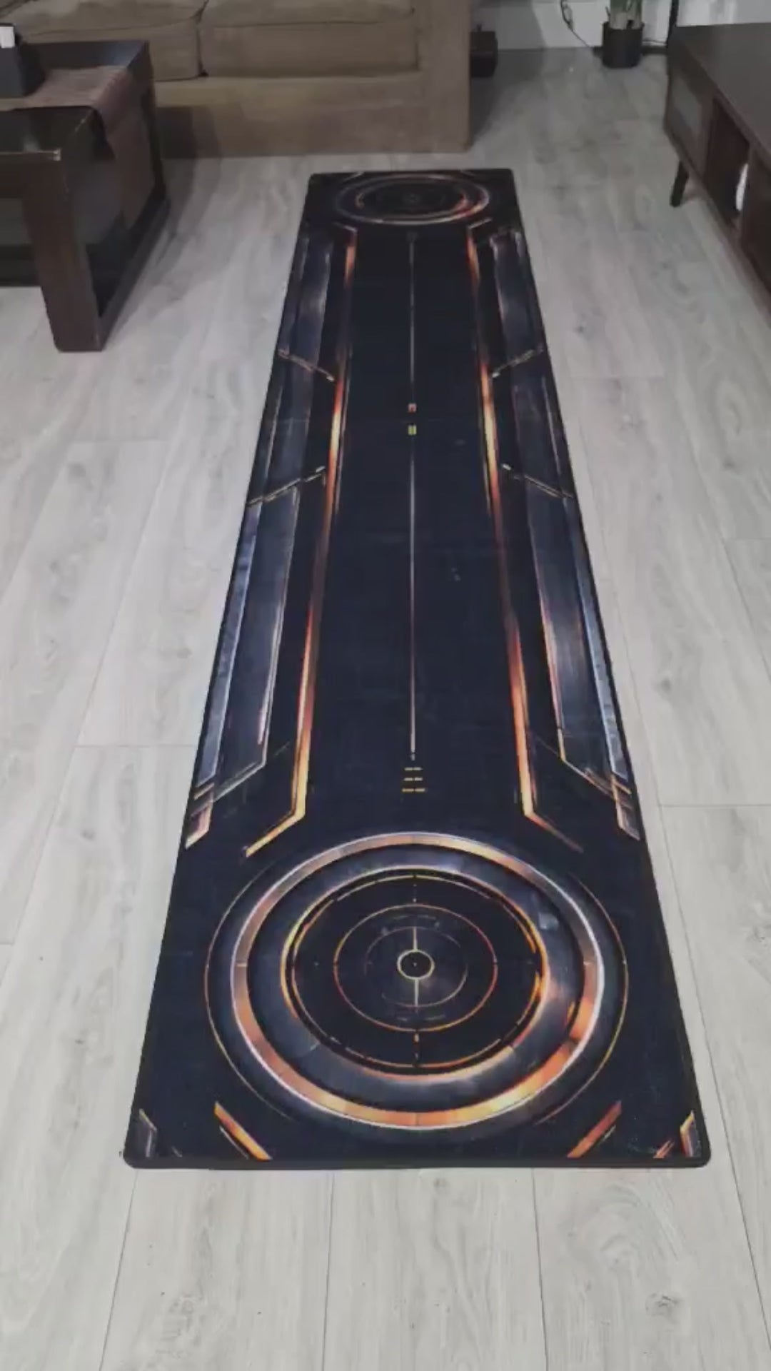 Video demonstrating the Eclipse™ designer putting rug for indoor putting practice in a modern living room.